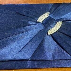 Navy blue pleated satin evening clutch with a crystal embellishment